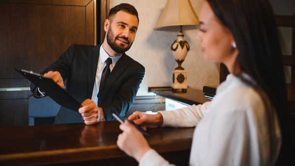 Guest checking in at a hotel front desk
